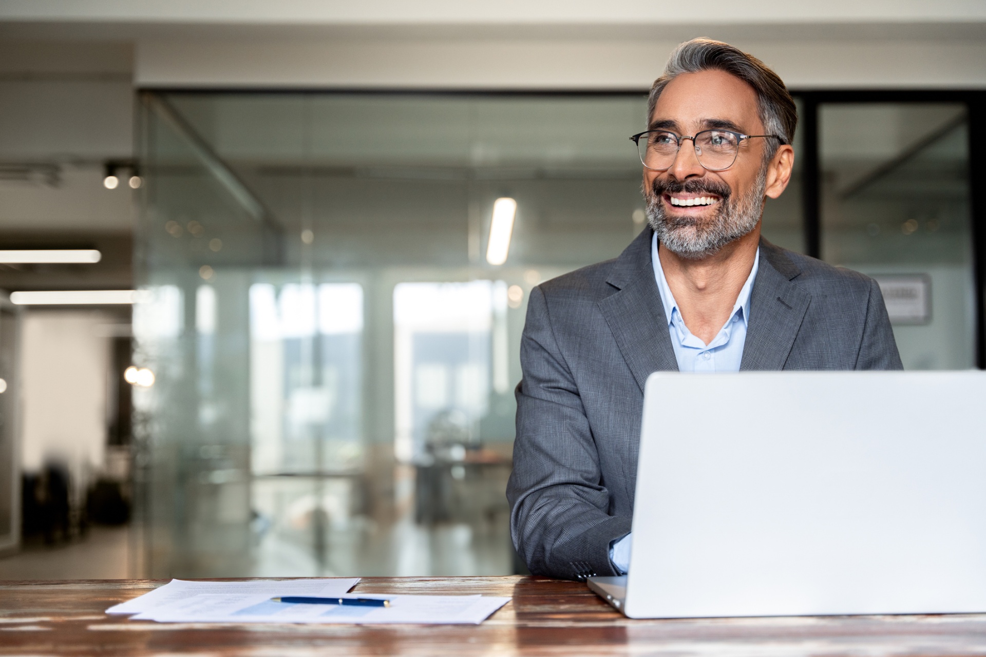 Smiling small-business owner forming their Florida LLC on a laptop
